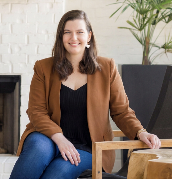 Kathryn McAdams of Meriwether Design Group seated in a bright interior.