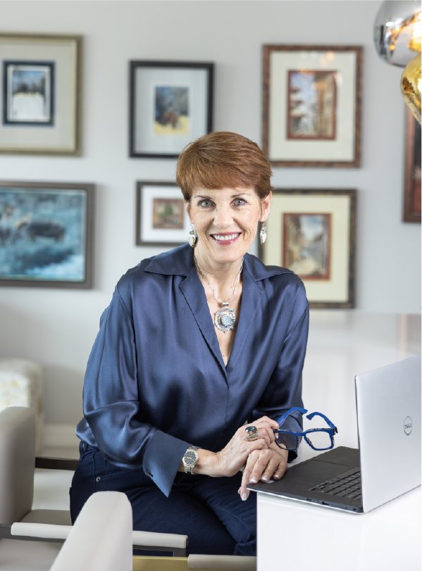 Melissa Galt seated beside a laptop in her office.