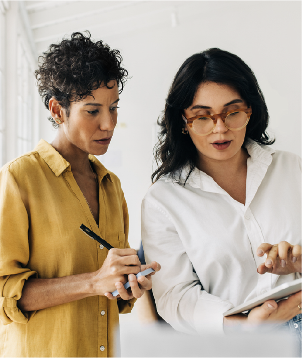 Two design professionals reviewing information together on a tablet.