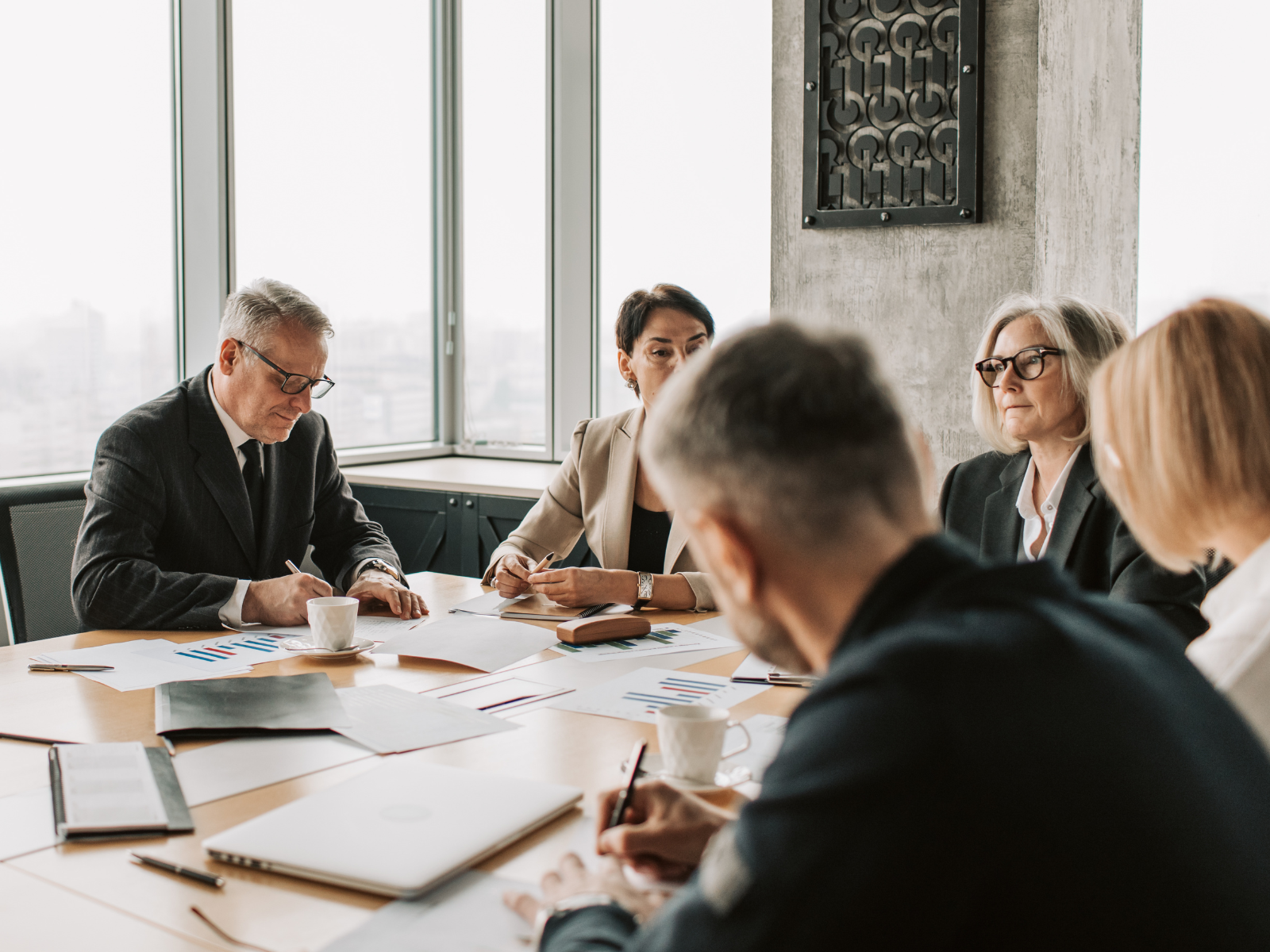 Senior professionals reviewing compliance, governance and regulatory risk matters in a formal meeting