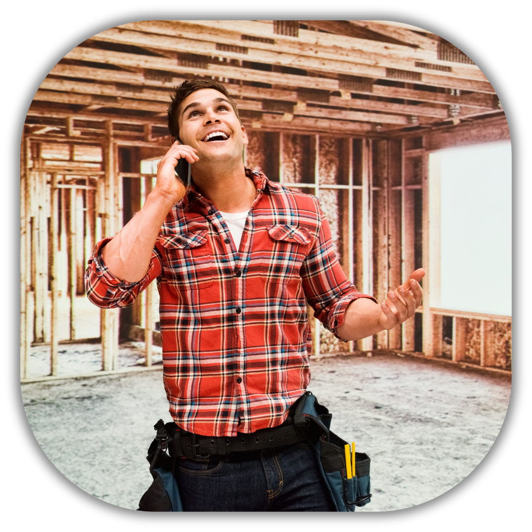 Happy residential contractor in a plaid shirt talking on the phone at a construction site, representing success and constant lead generation for contractors using automated marketing strategies.​