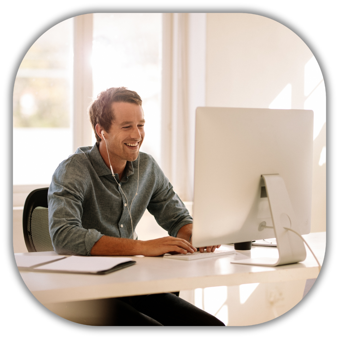 Smiling professional working at a desk, representing dedicated one-on-one support from an expert to help contractors grow their business.