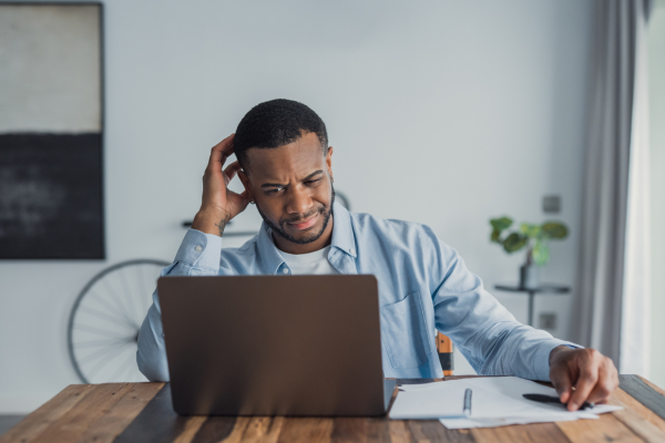 Driver reviewing paperwork with a confused expression