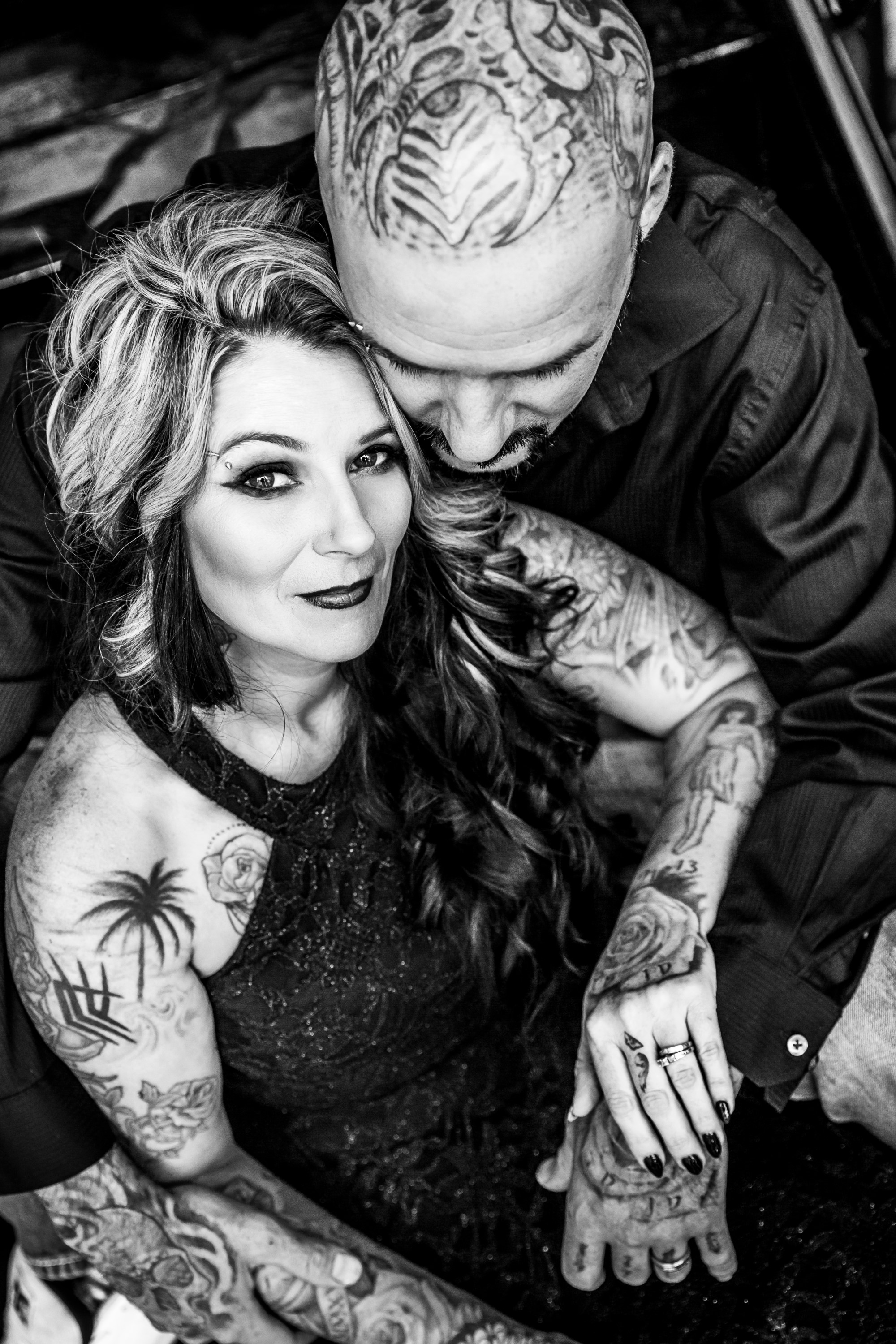 tattooed couple embracing