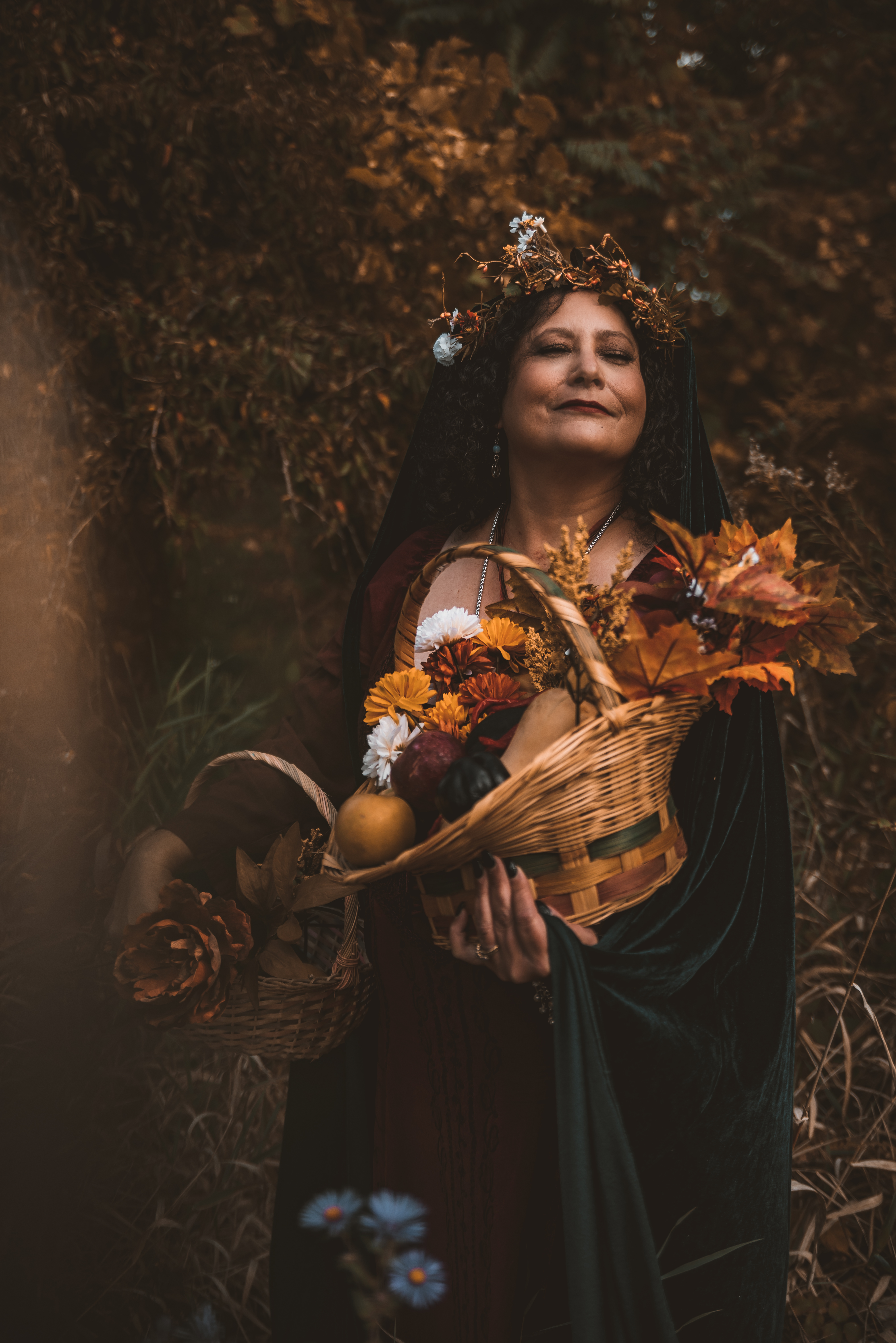 woman holding basket of autumn foliage