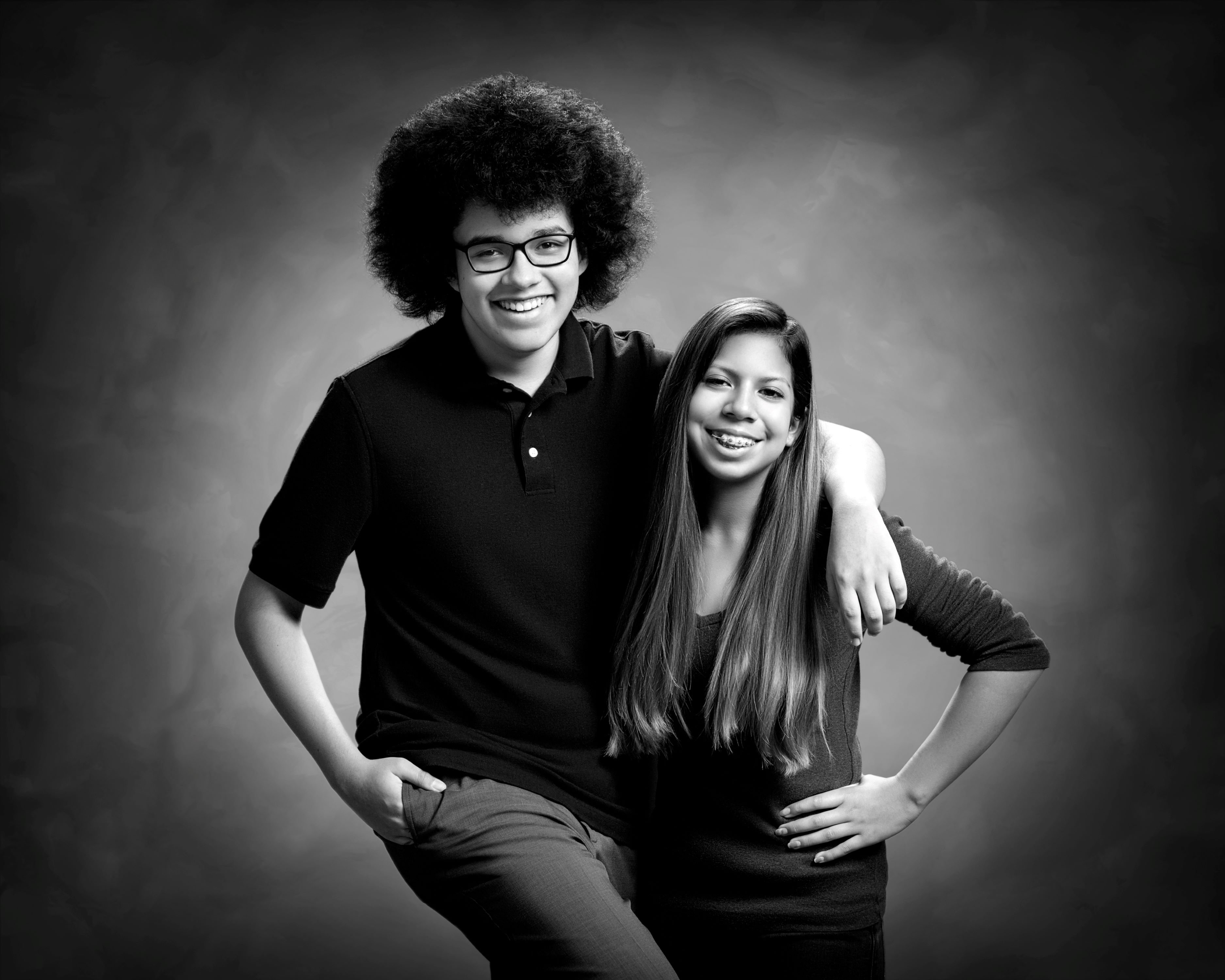 black and white studio portrait of young man and woman