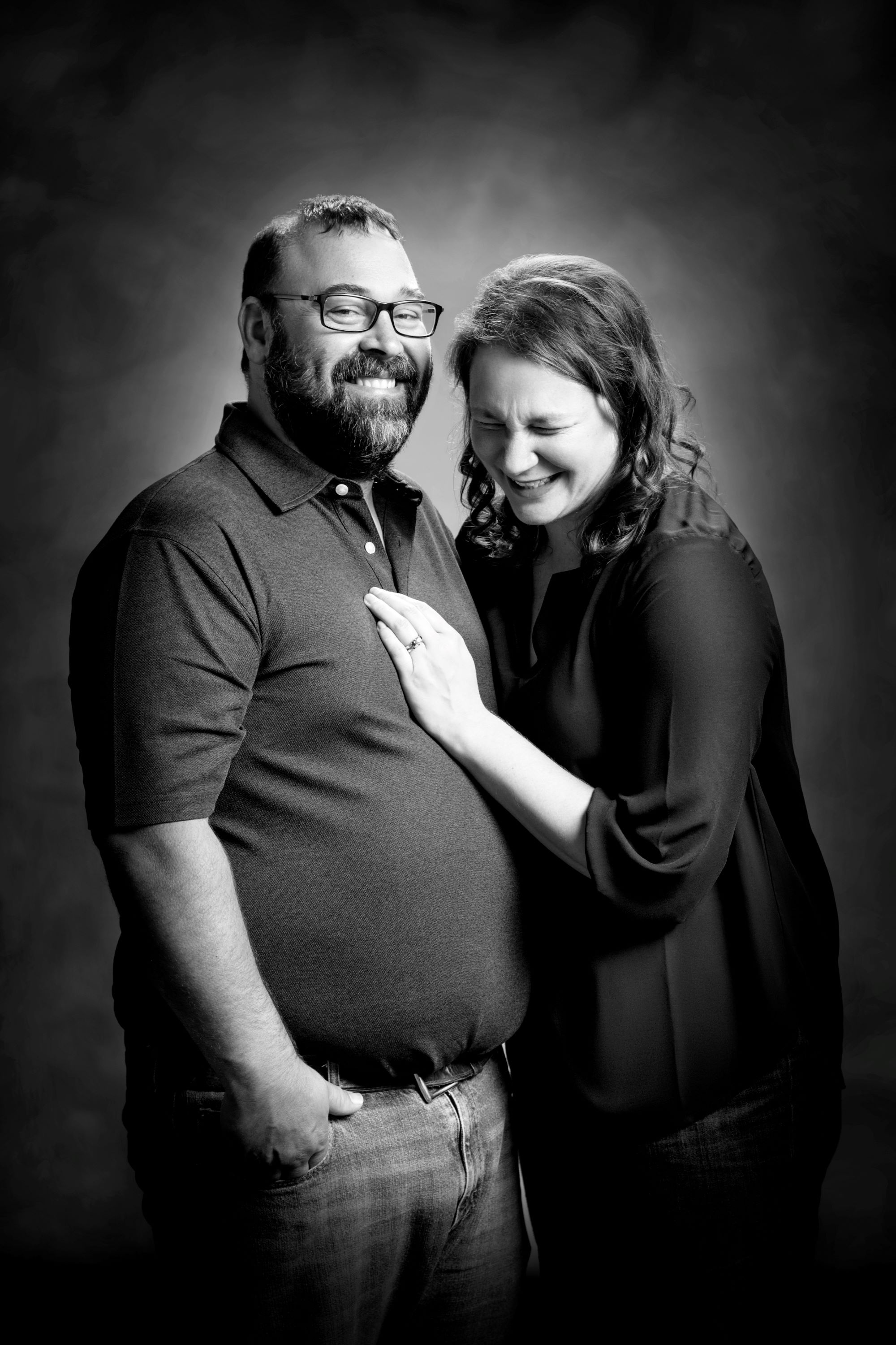 black and white studio portrait of man and woman