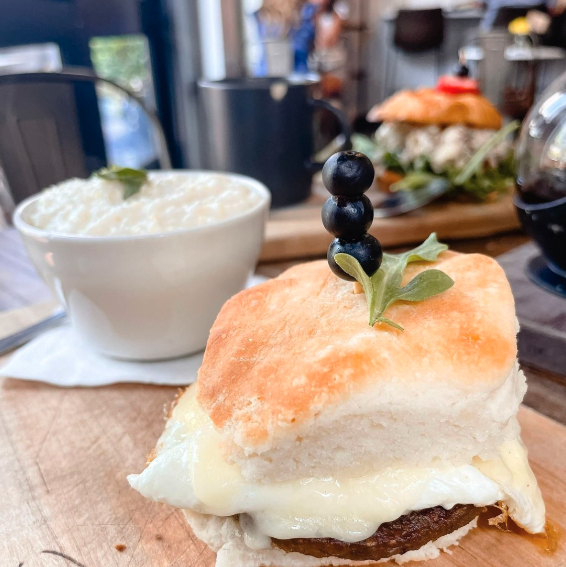 Sausage, egg, and cheese biscuit sandwich with grits at Rushing Trading Co.