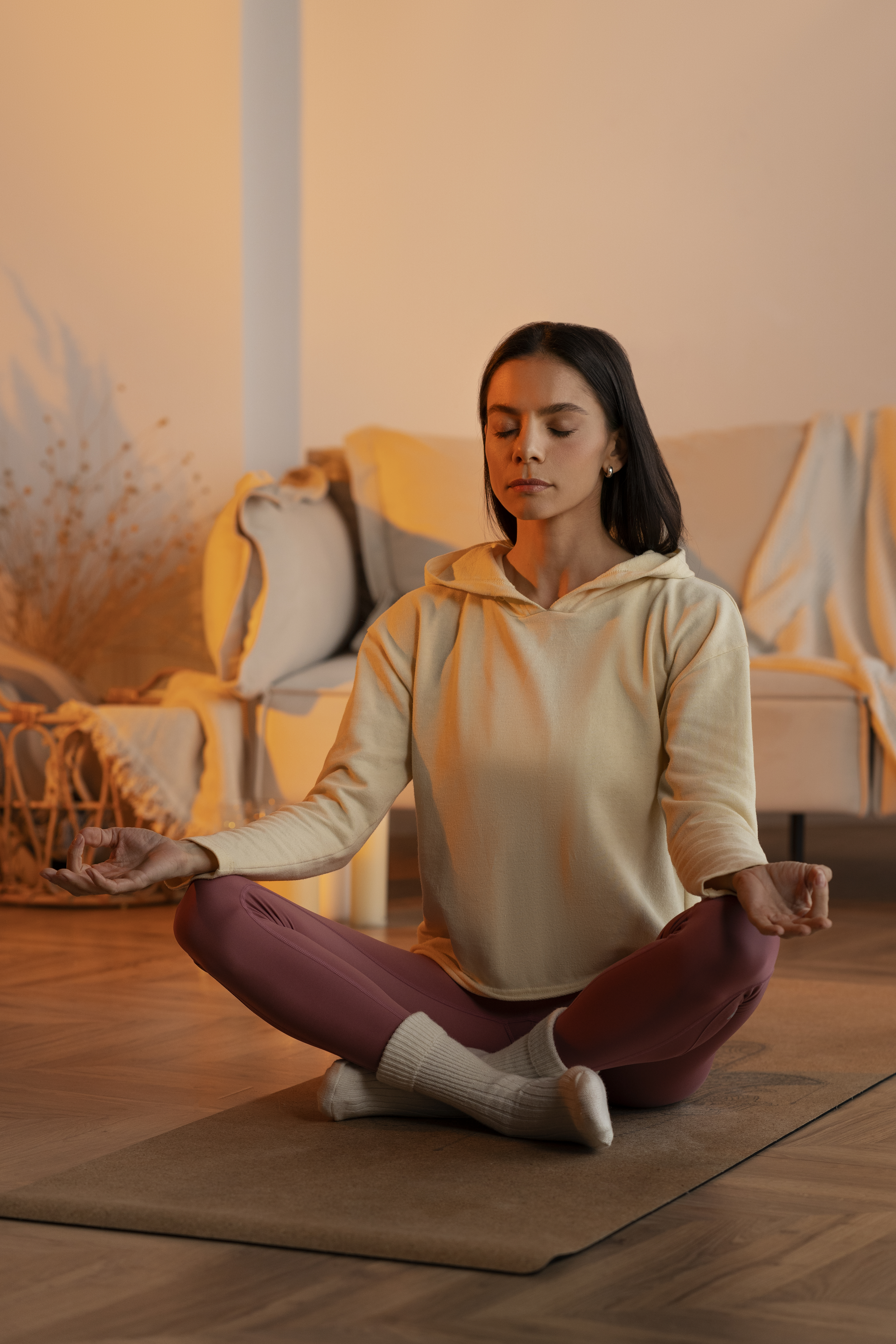 Woman sitting cross-legged in meditation, finding inner peace through breathwork.