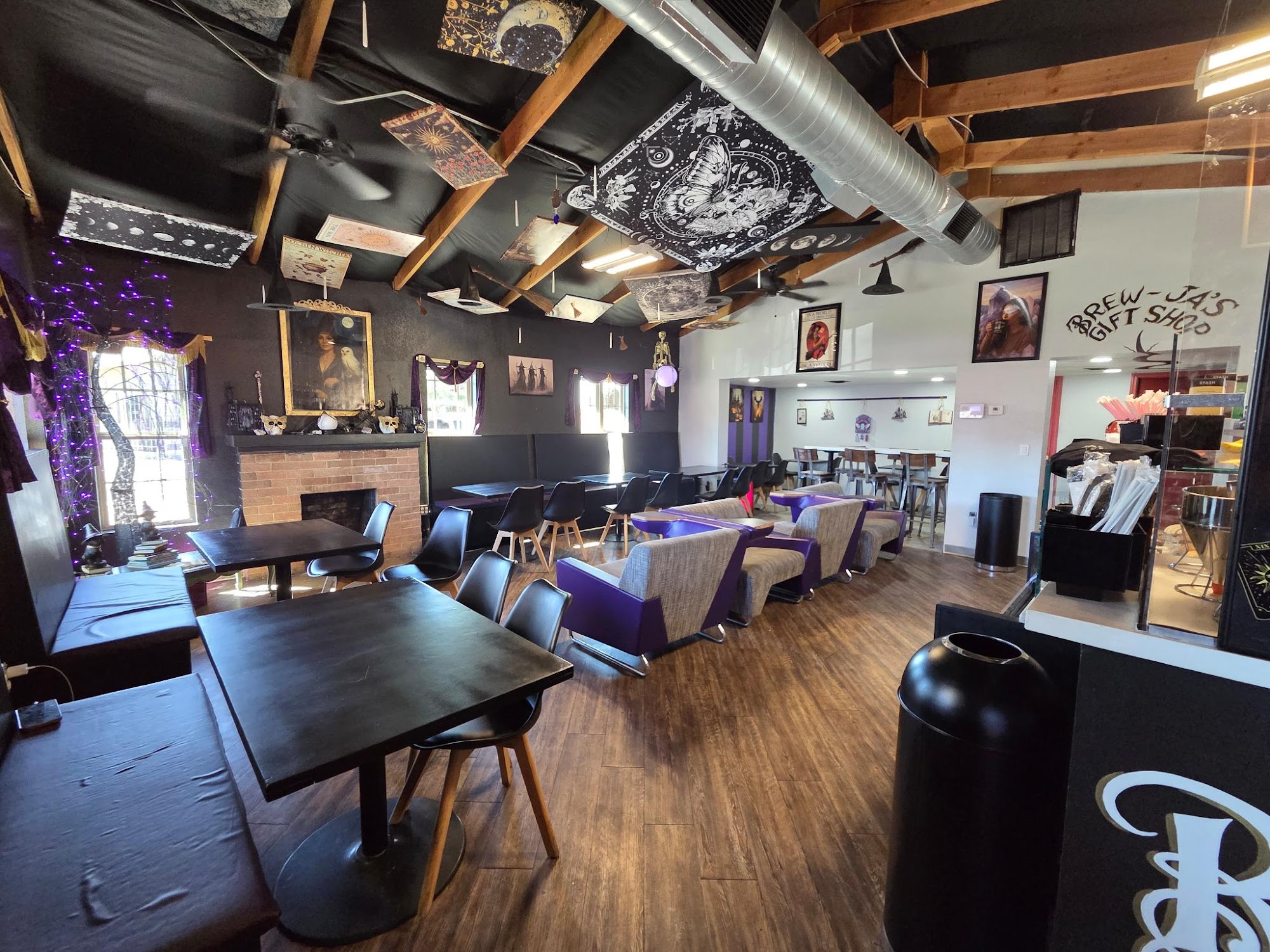 Brew-Ja's Coffee wide interior — seating area, Gift Shop section, ceiling tapestries, wood beams