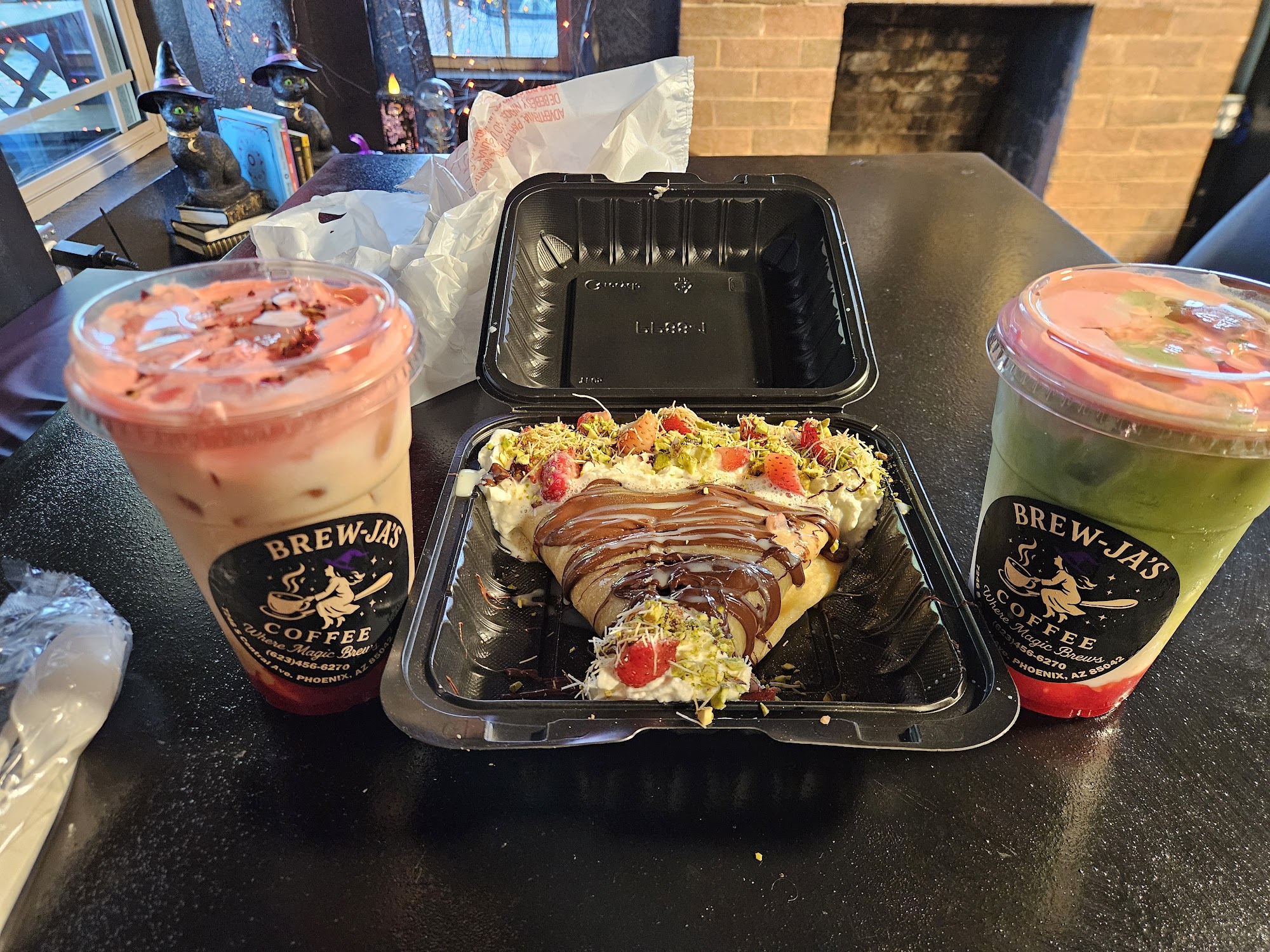 Combo — Rose Quartz latte, Dubai Dreams crepe with pistachio and strawberry, and matcha on dark table