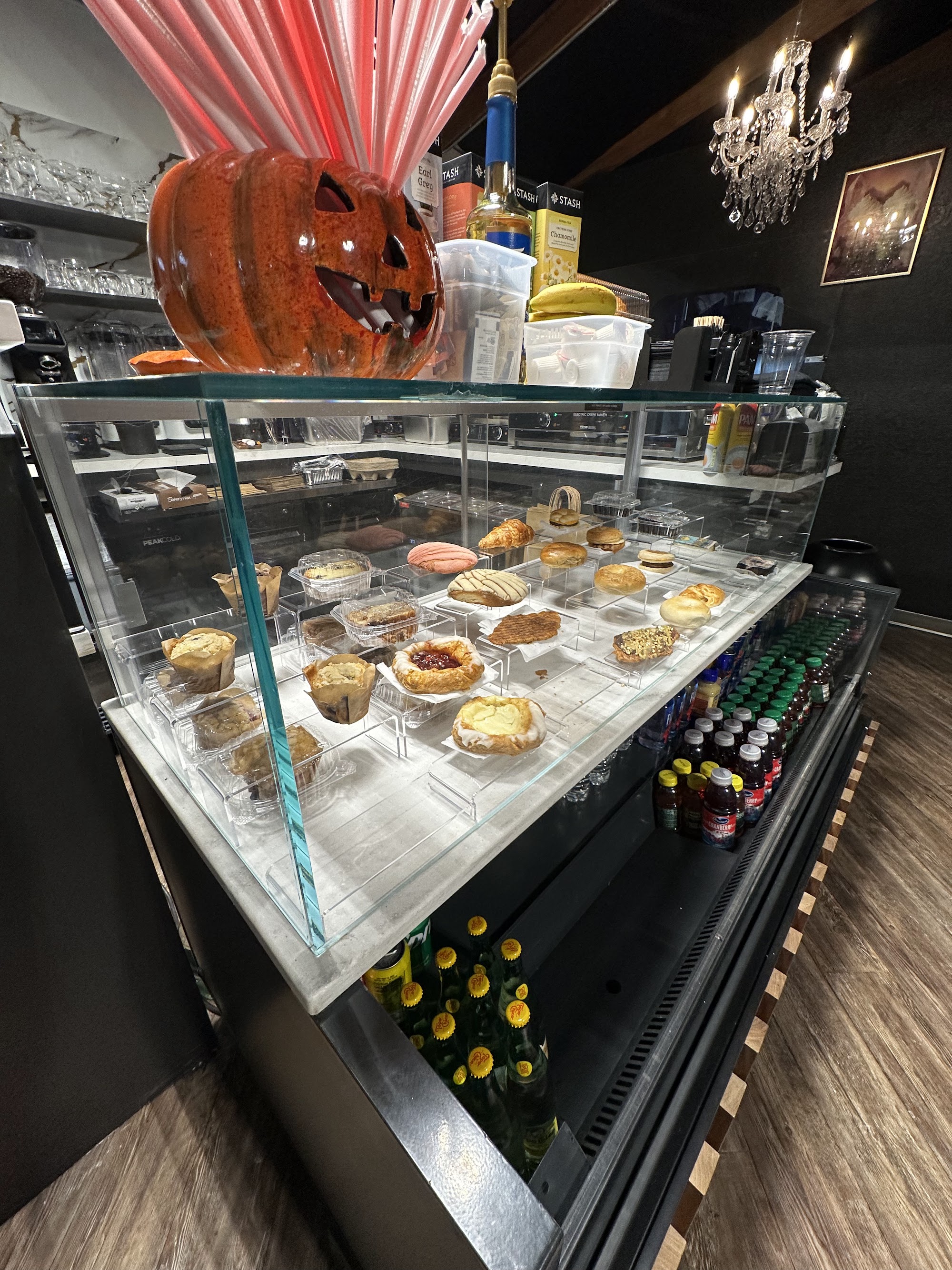 Brew-Ja's pastry display case with muffins, tarts, conchas, and croissants