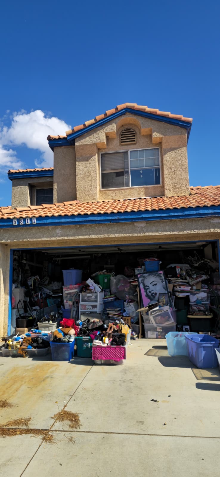 Two-story stucco home with full-garage cleanout situation purchased as-is by Astra Home Buyer