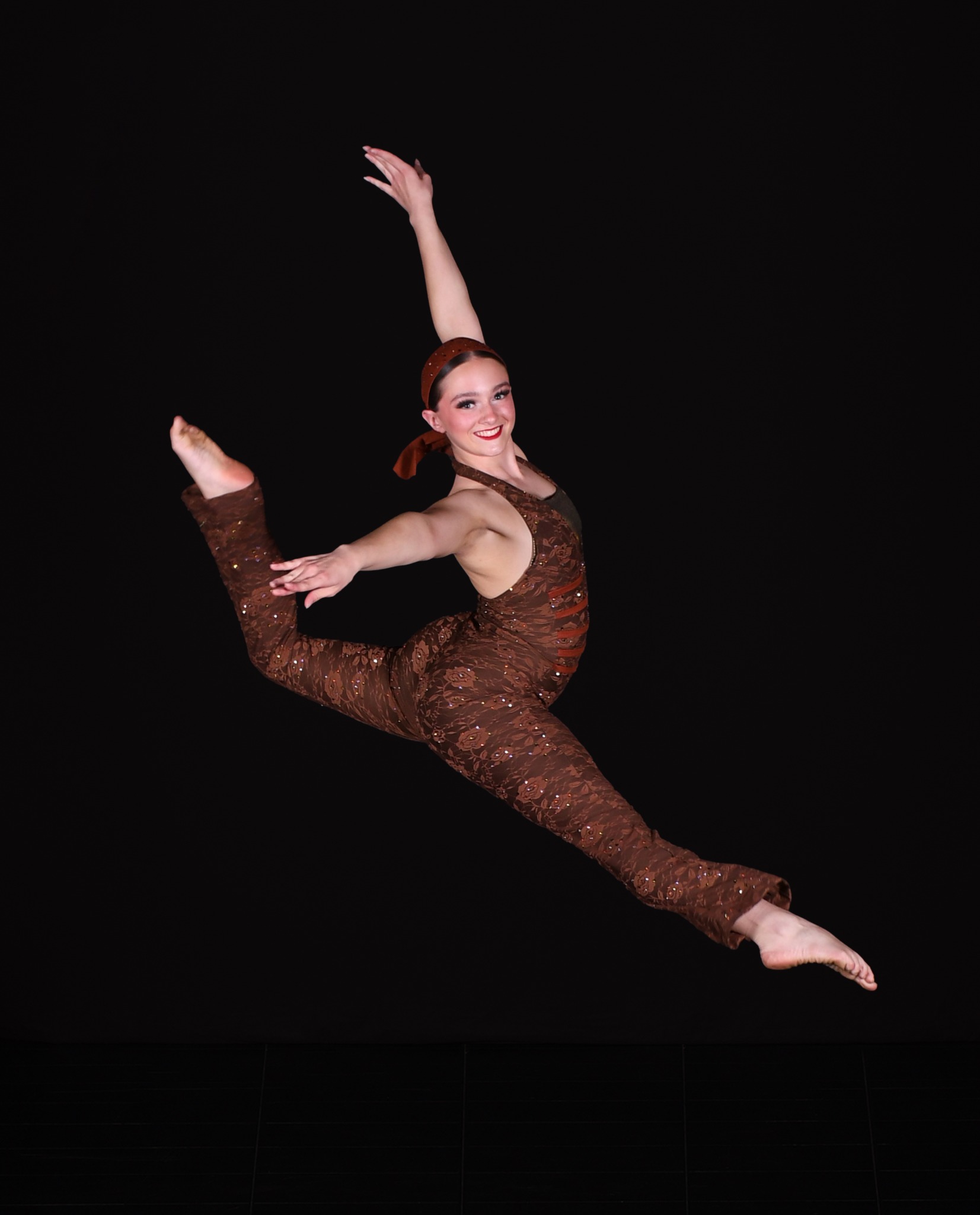 Kore dancer leaping in a brown costume