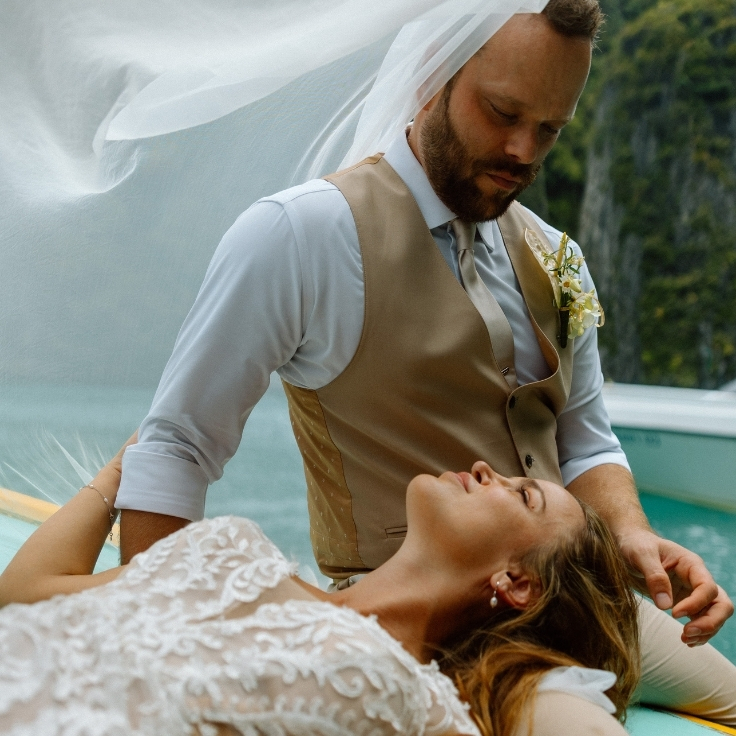 newly married couple on a longtail boat in phi phi islands thailand