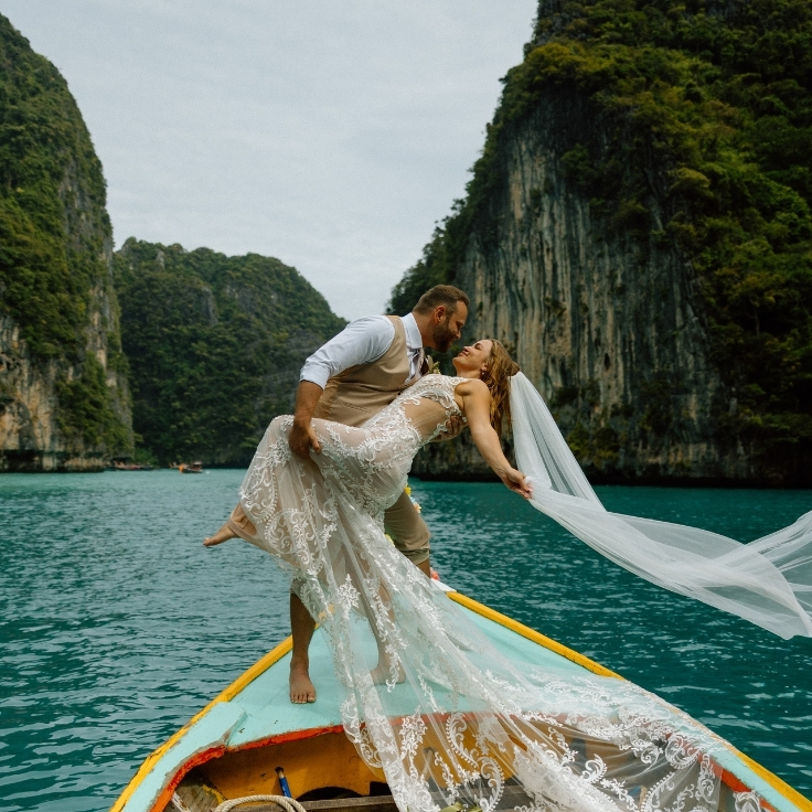 newlywed elopement couple on long tail boat in pi ley bay thailand
