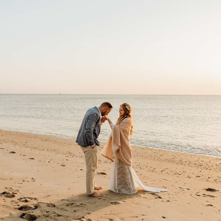 mermaid bride laughing and playing on beach with groom at sunset during Cape May elopement mermaid bride laughing and playing on beach with groom at sunset during Cape May elopement