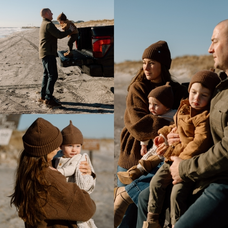 Intimate winter beach family moment with parents and their two young children cuddled together on a truck tailgate, wrapped in warm layers by the ocean.