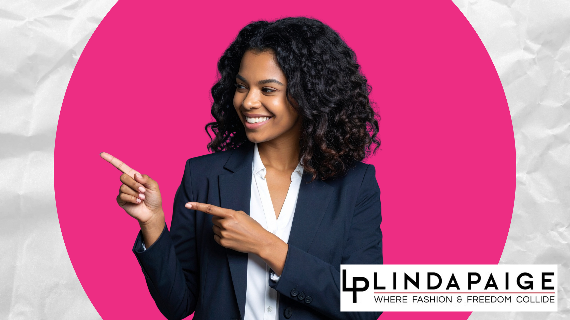 Smiling woman in navy blazer pointing confidently to the side on a pink background