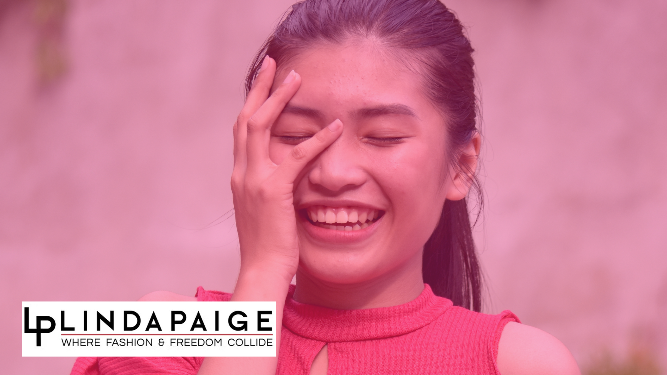 A woman laughing while holding her face