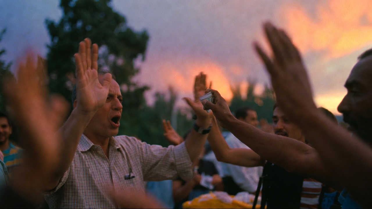 People raising hands during an outdoor event