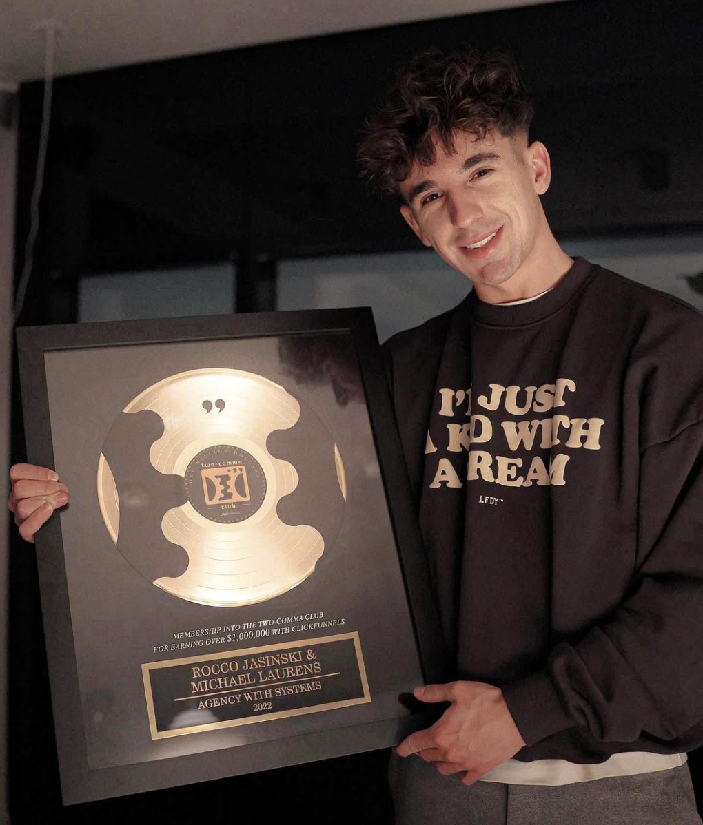 Rocco Jasinski holding his ClickFunnels Two Comma Club award