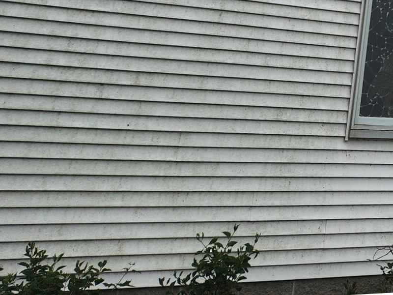 Dirt and grime buildup on faded vinyl siding