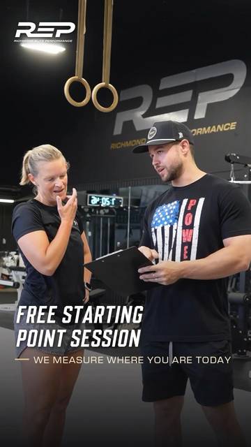 A REP coach reviewing a member's plan on a clipboard in the gym