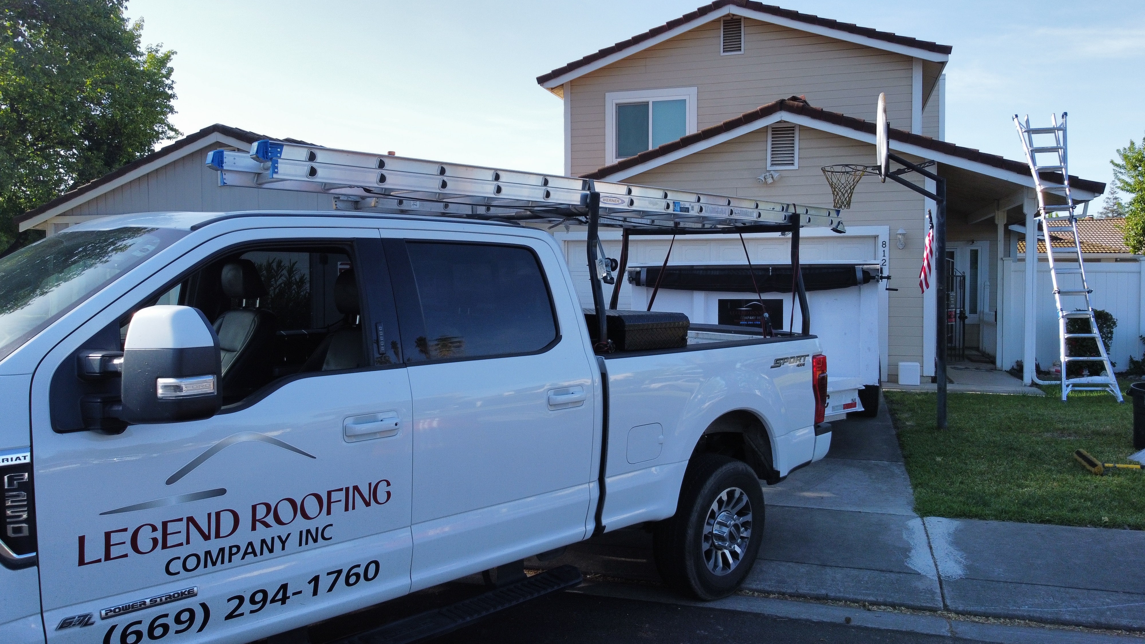 Legend Roofing Company - Expert Roof Replacement - roofing expert installs new roof tiles on the top of resi