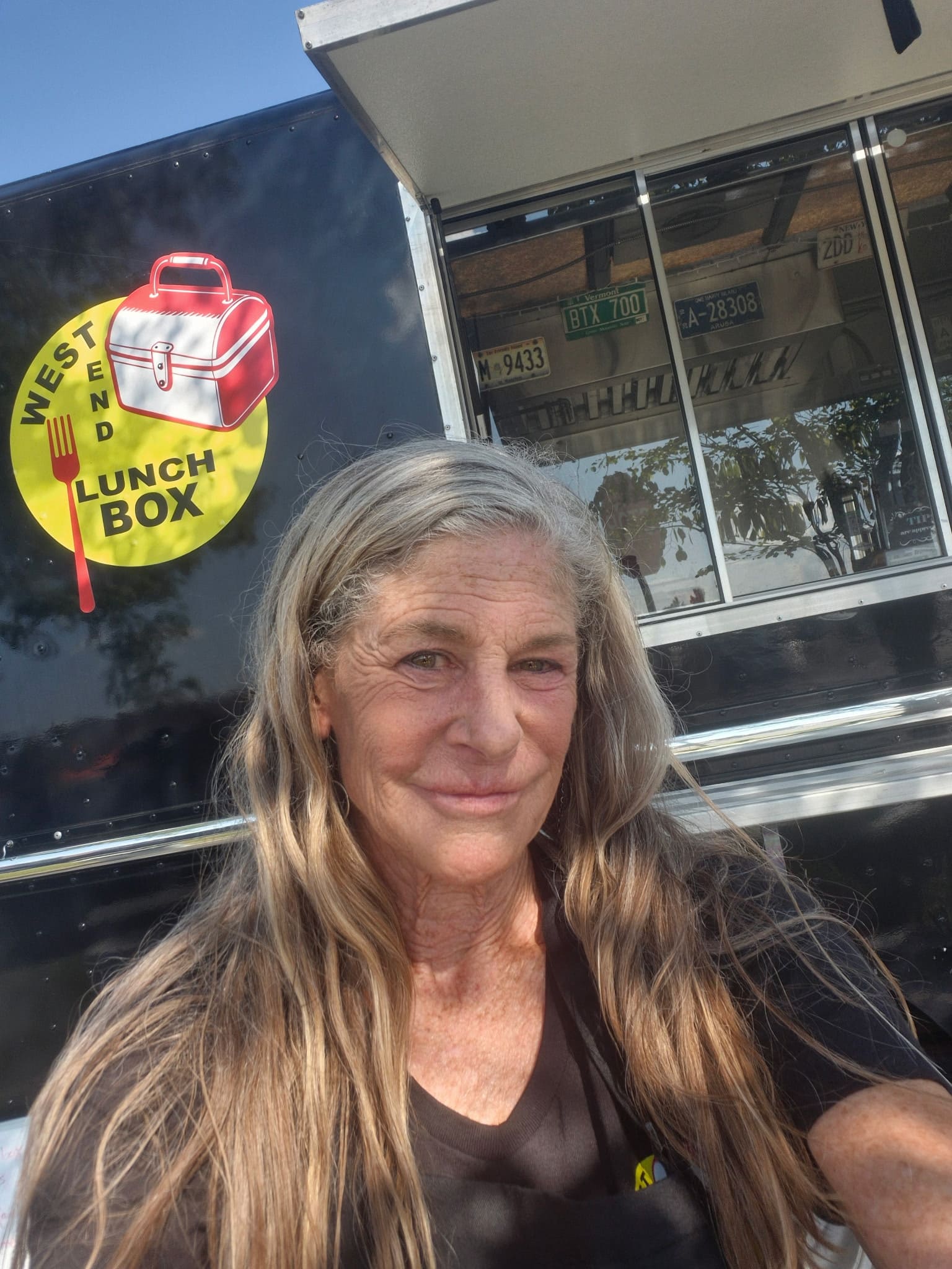 Mandy, owner of West End Lunch Box, pressing fresh smash burgers