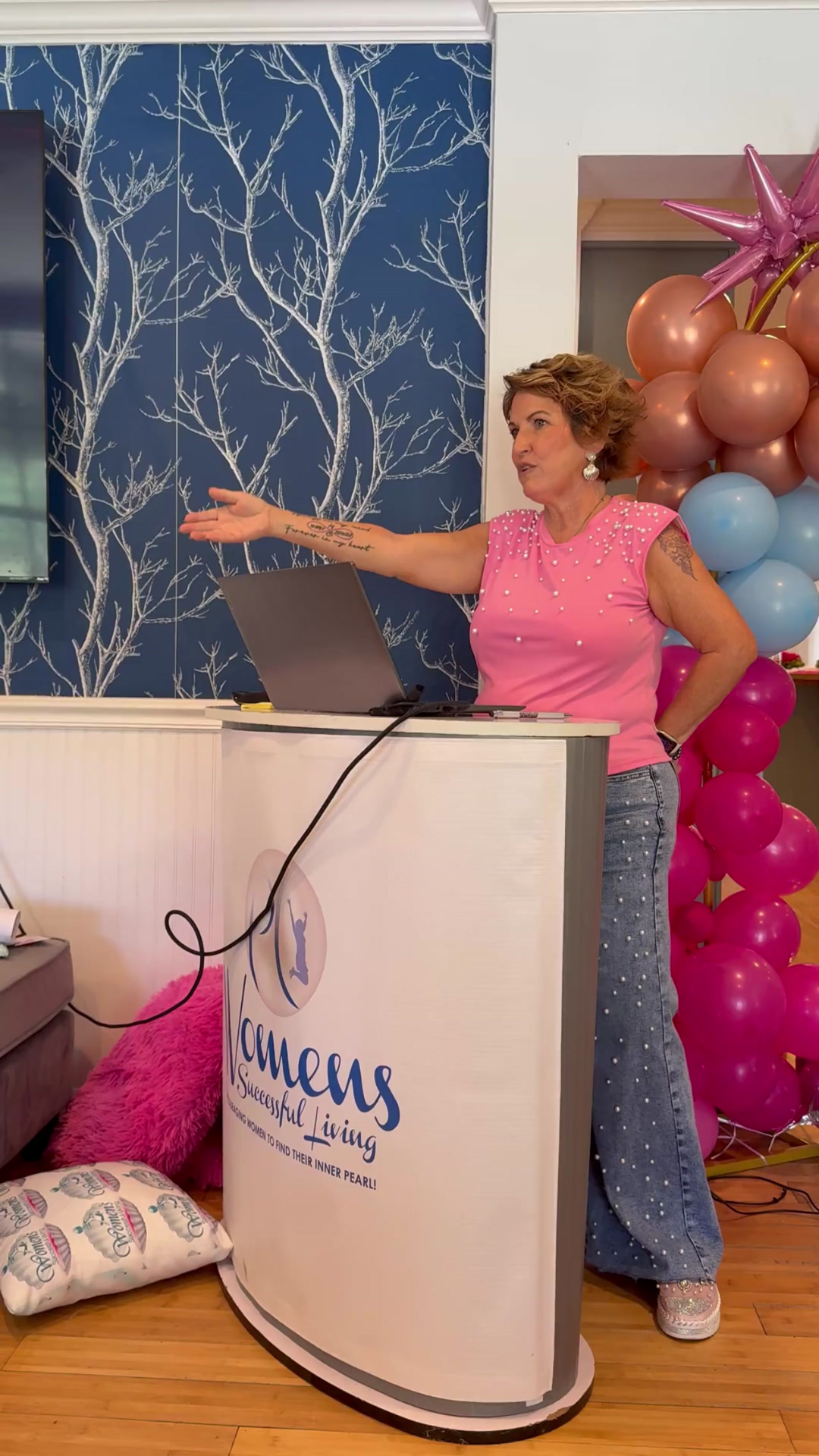 Coach Pearl at the summit standing while giving a empowering speech to attendees