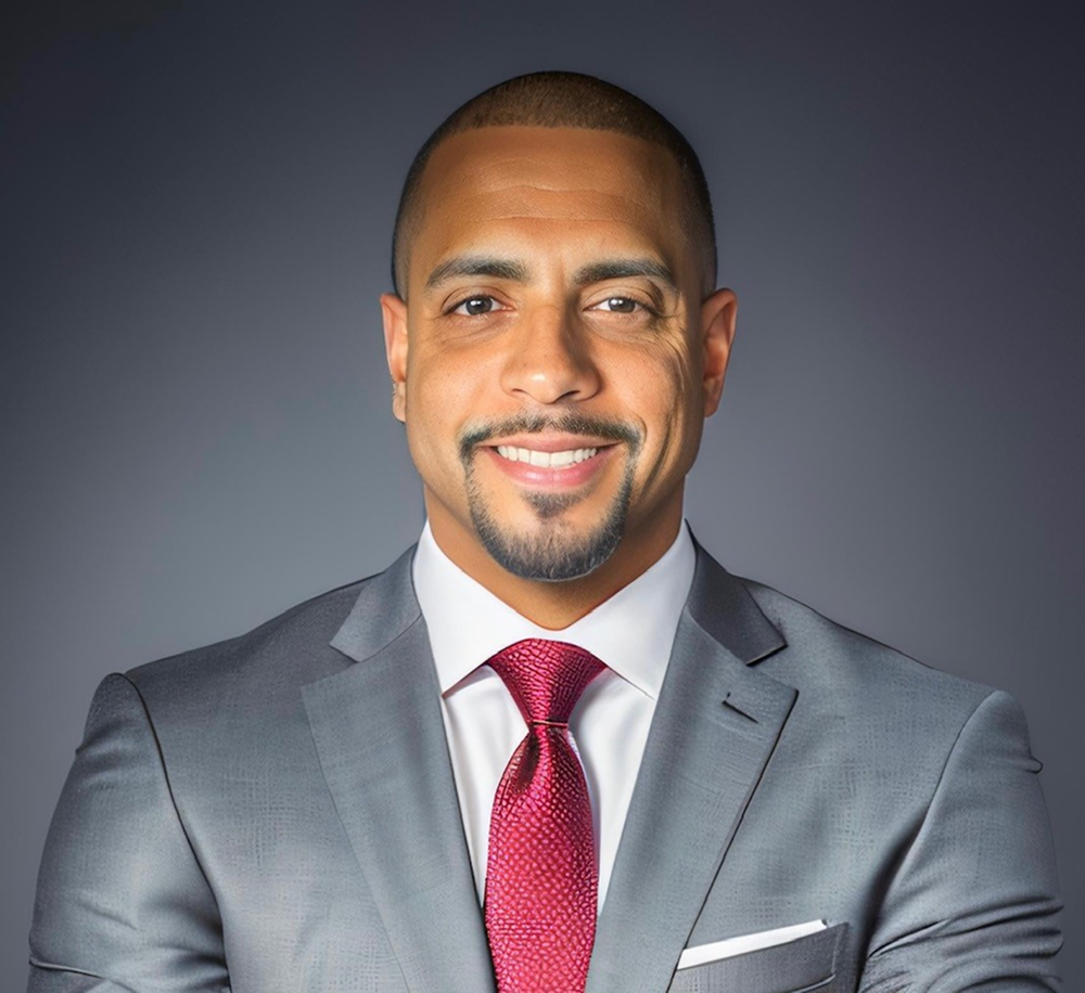 Person writing on documents with a pen at a desk, computer monitor in background, emphasizing compliance with New York LLC filing requirements.