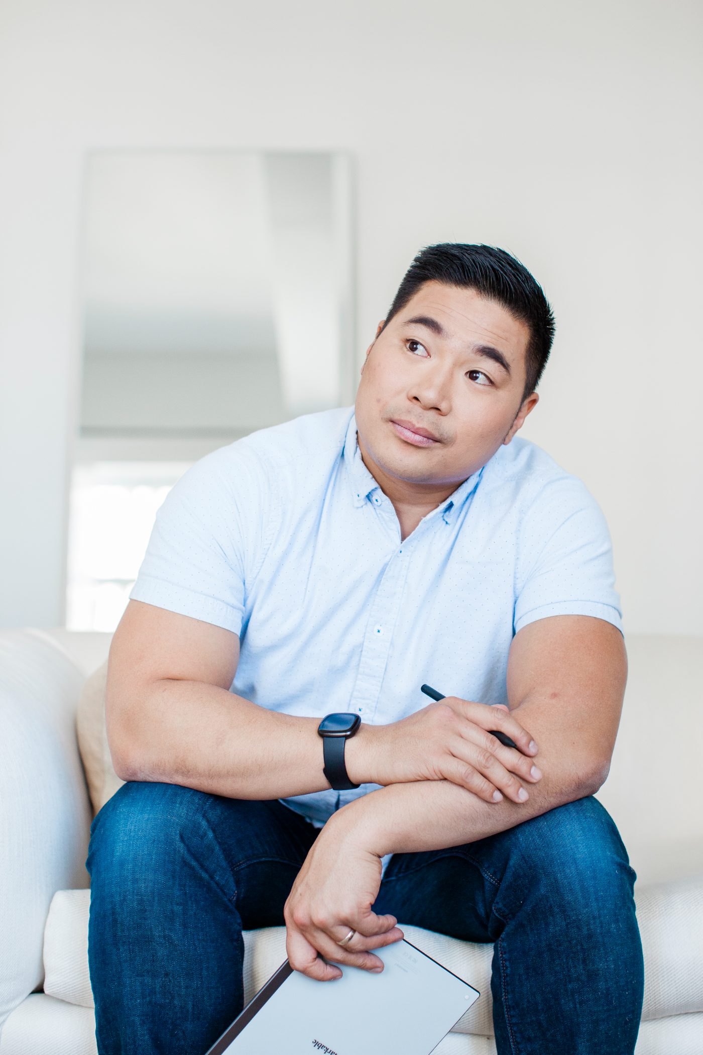 Portrait of Kevin holding a tablet and pen