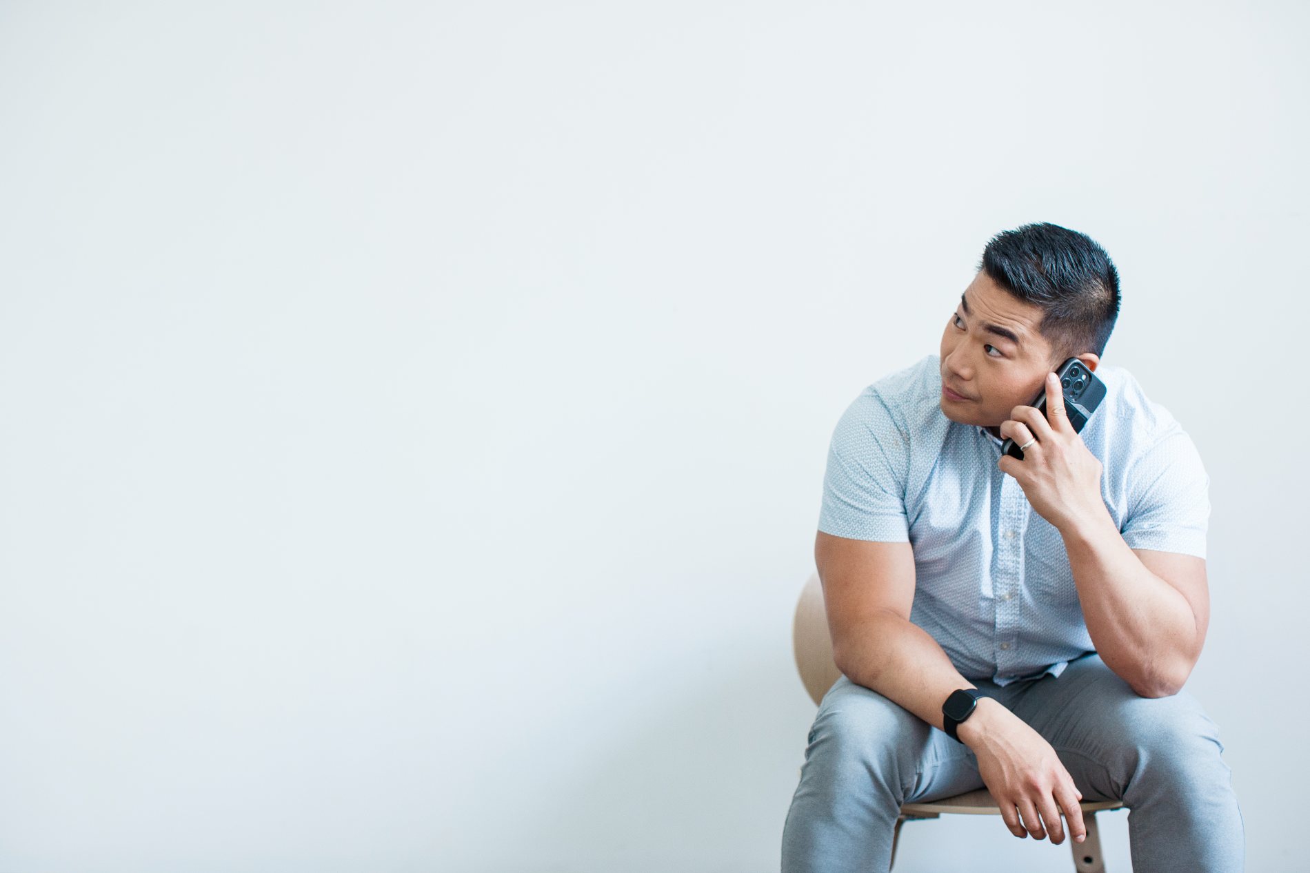 Kevin, founder of Up and Right Growth, seated on a chair taking a phone call