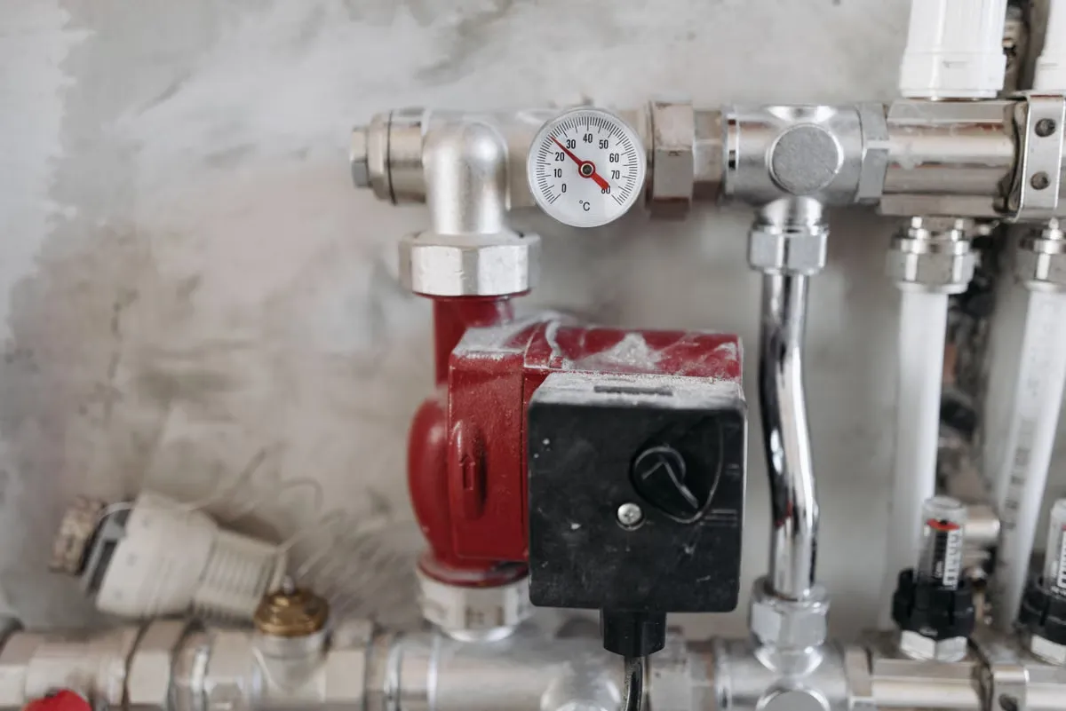 A plumbing system with a pressure gauge and steel pipes