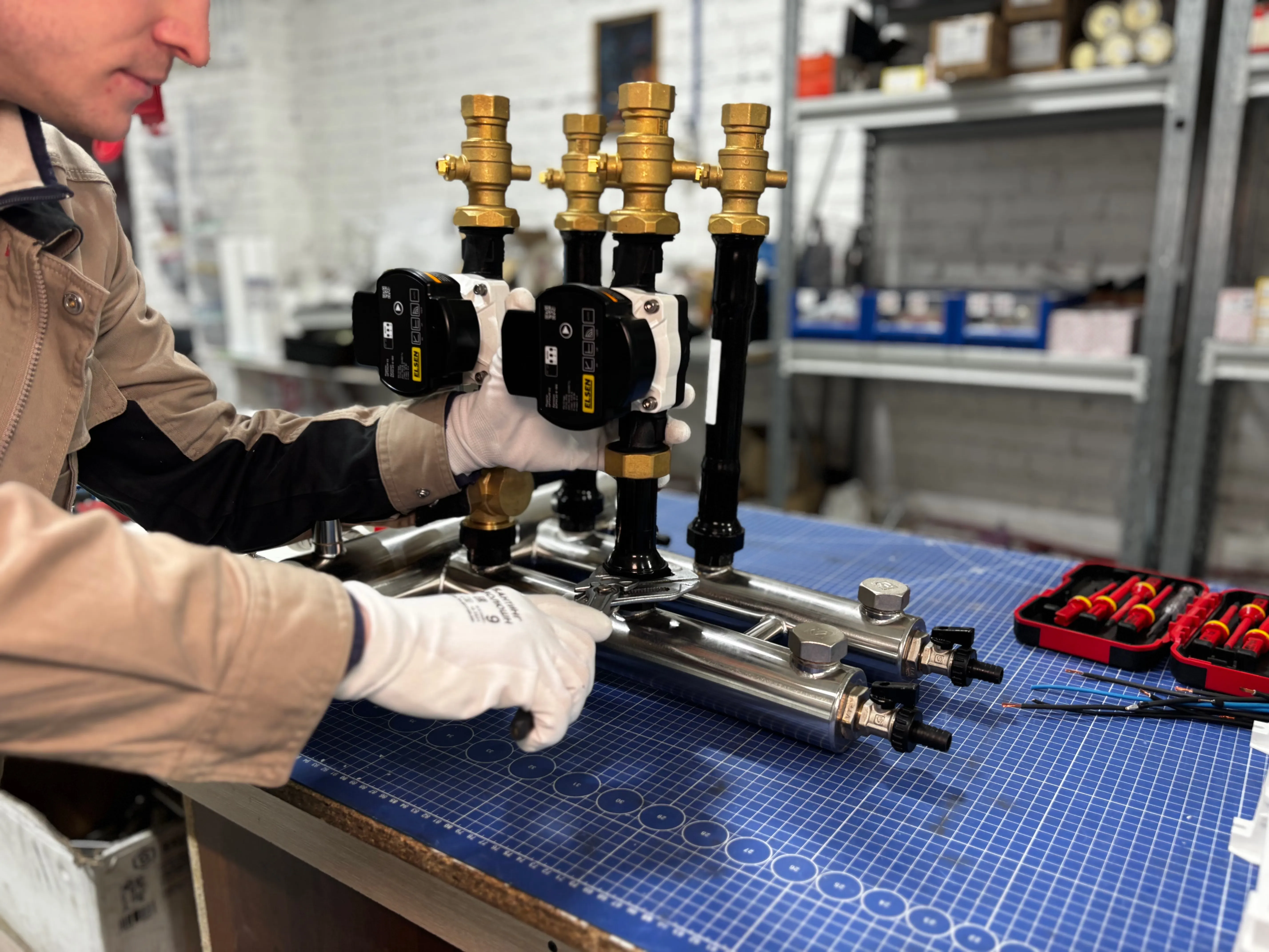 An engineer assembling a piping system with valves and control units