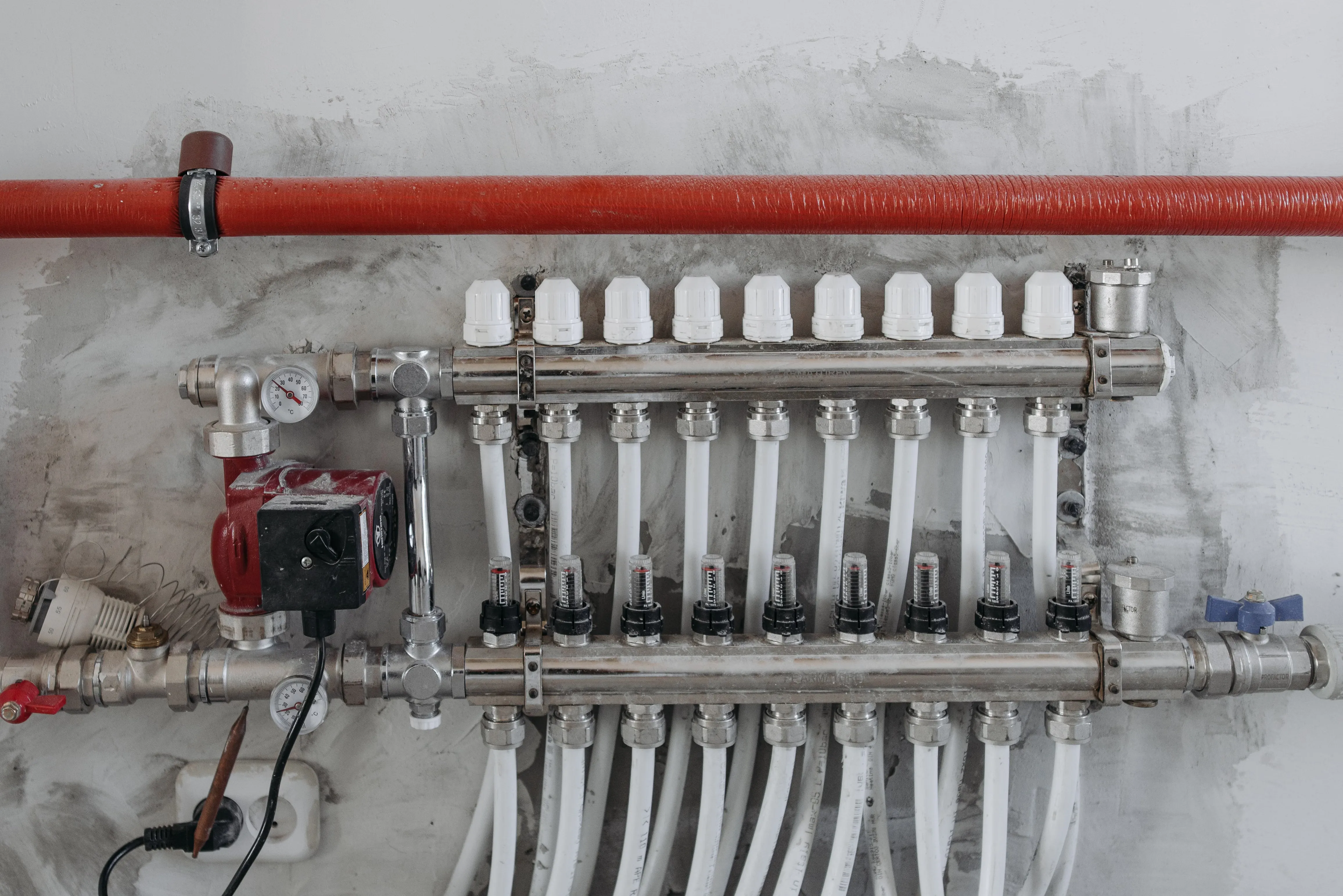 An industrial manifold with pressure gauges and connected steel pipes