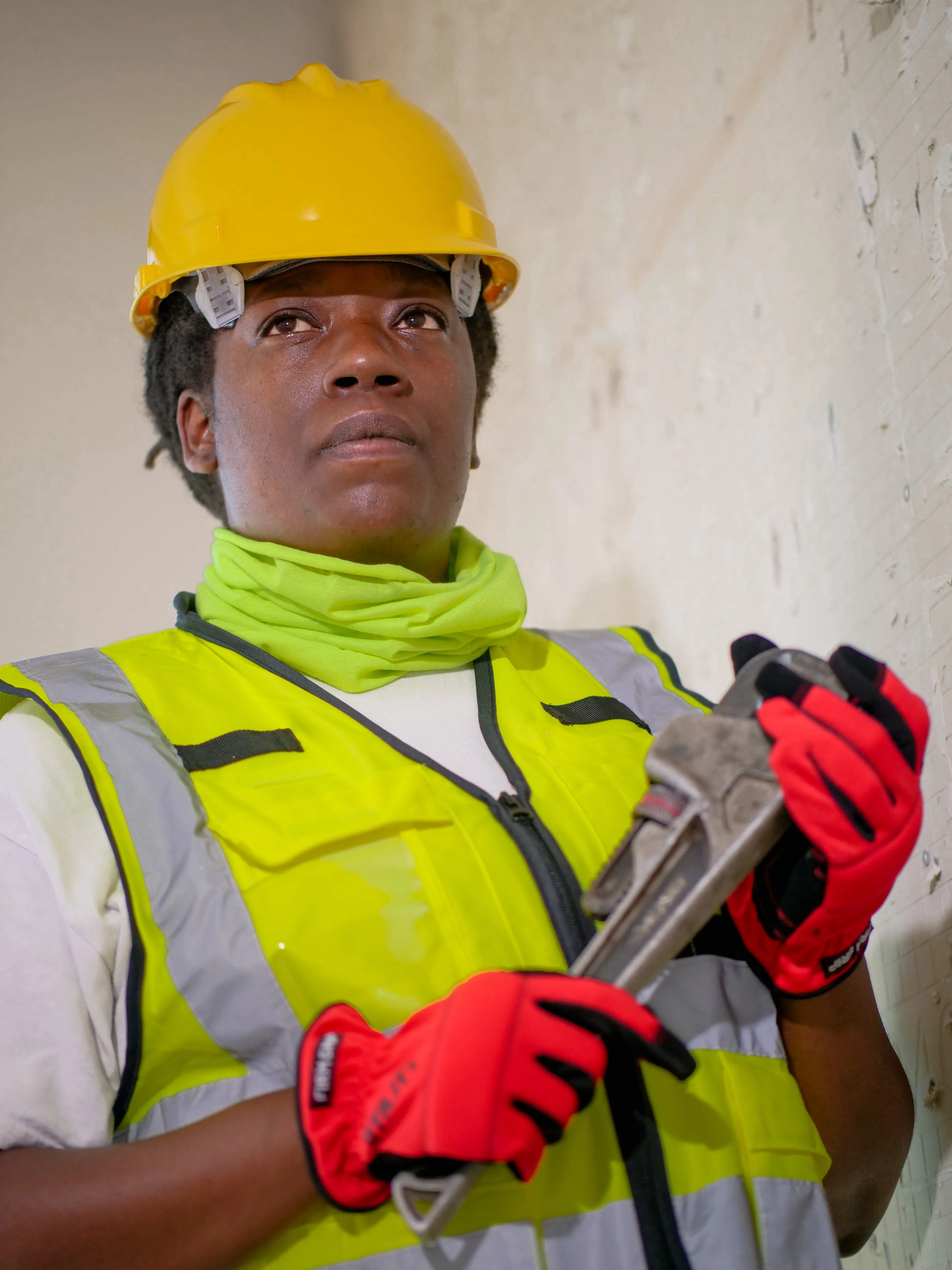 A professional plumber in protective gear ready for work