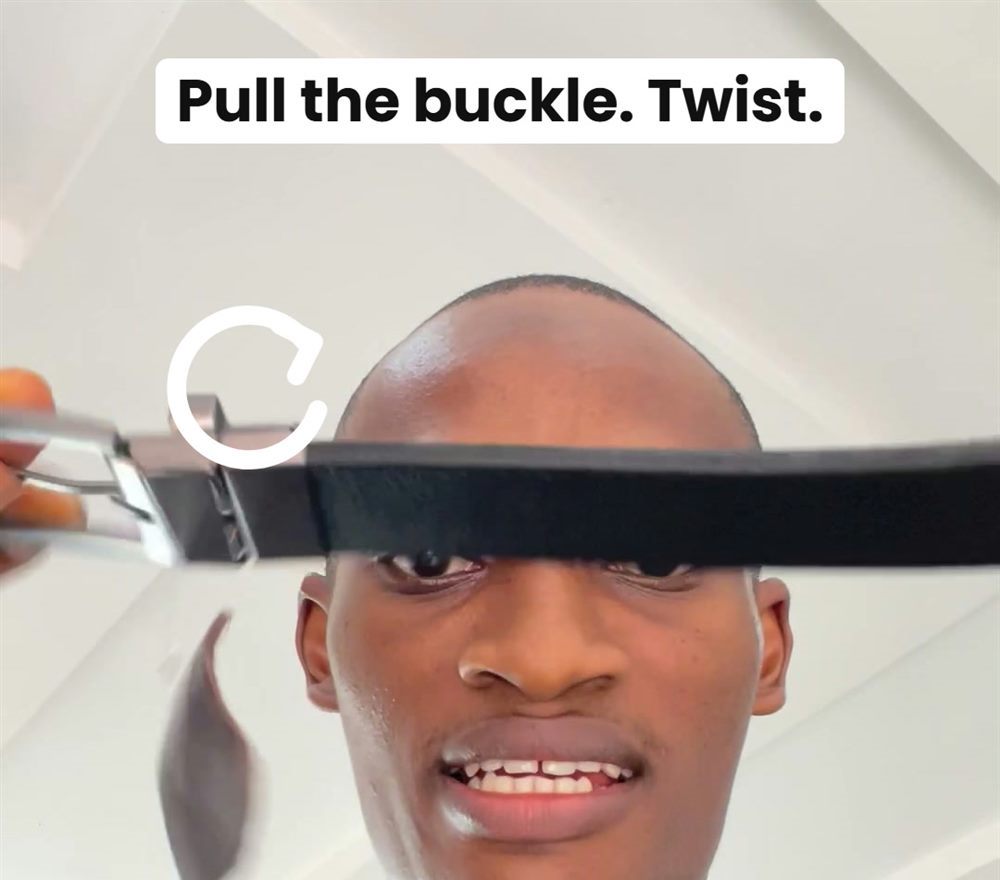 Man pulling the buckle to switch the belt colour
