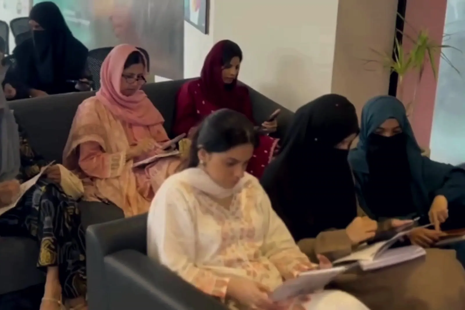Participant taking notes at Scale Her Business with AI™