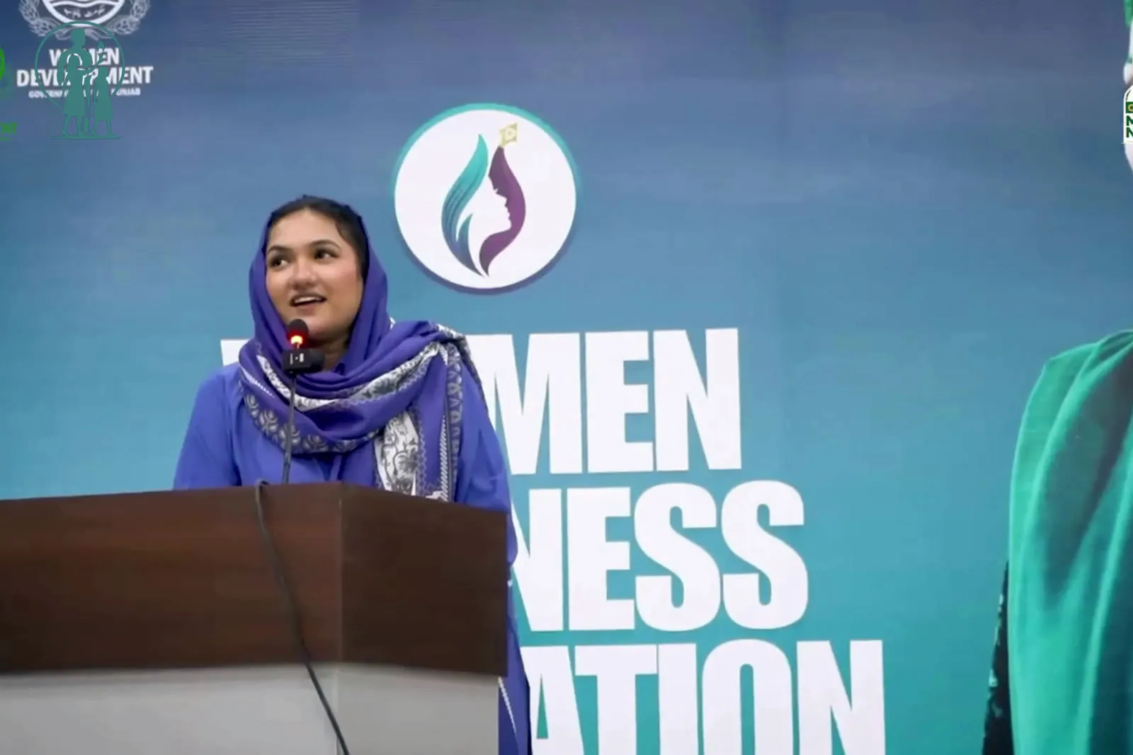 A speaker at the podium during the Women in AI and Revenue Growth Masterclass