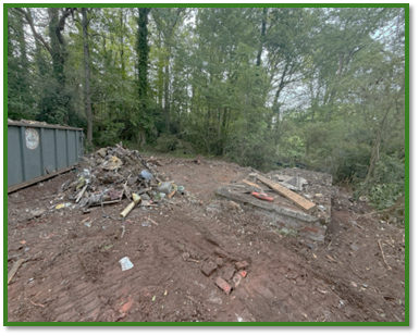 Cleared lot at 666 Sheppard Road following demolition, with remaining debris piles and exposed ground where a severely blighted home once stood.