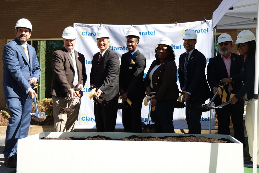 Commissioner Chakira Johnson joins local leaders and partners in a ceremonial groundbreaking at Claratel Behavioral Health, wearing a hard hat and holding a shovel alongside a group of officials.