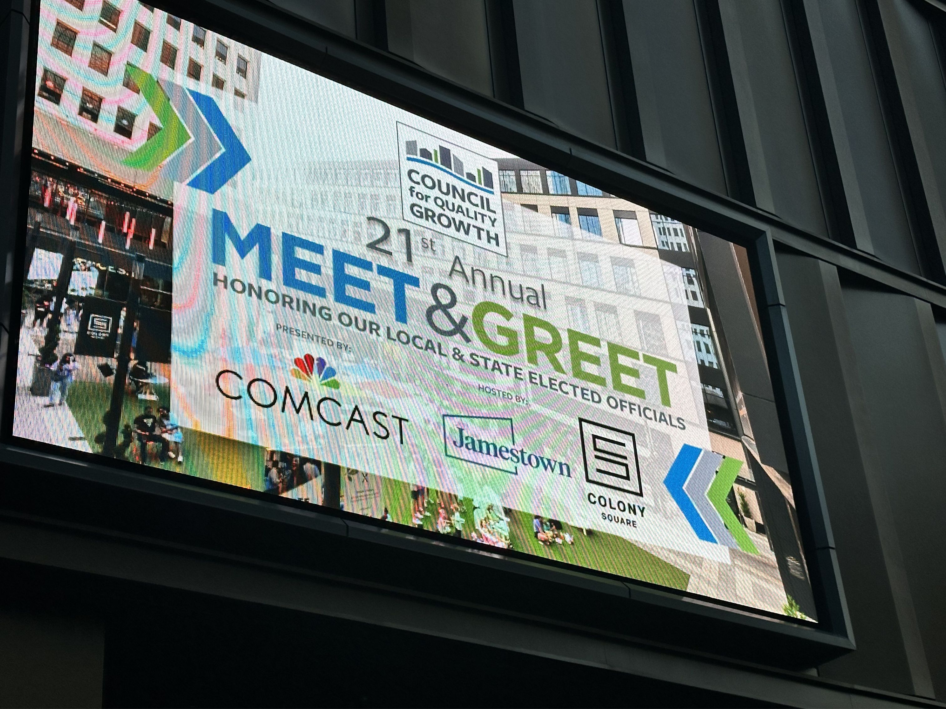 Large digital display promoting the Council for Quality Growth’s 21st Annual Meet & Greet event honoring local and state elected officials. The screen includes event branding and sponsor logos for Comcast, Jamestown, and Colony Square.