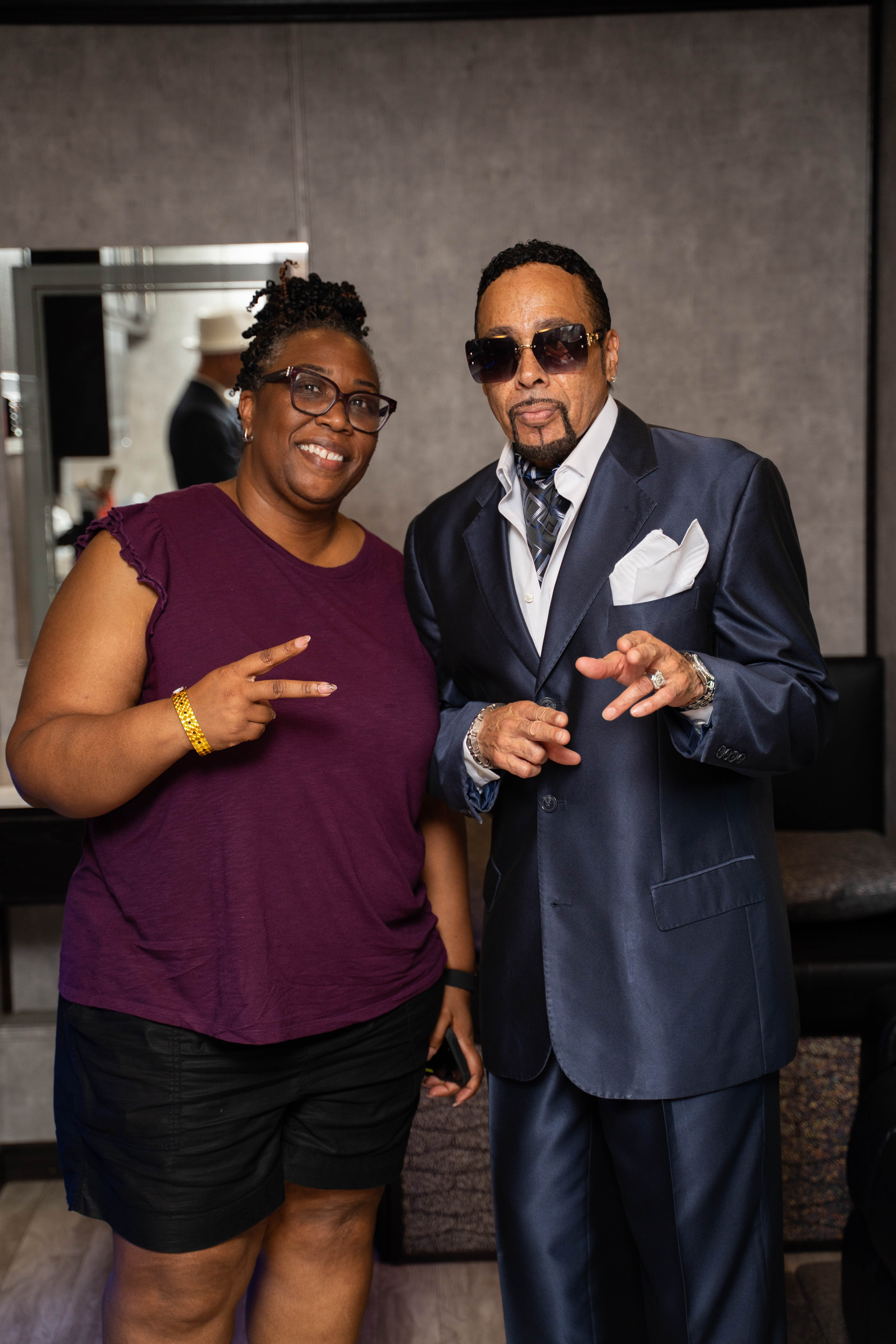 Commissioner Chakira Johnson smiles while posing for a photo with Morris Day of Morris Day & The Time following the band's performance at DeKalb County's Juneteenth Festival on June 13. Both face the camera inside the event venue.