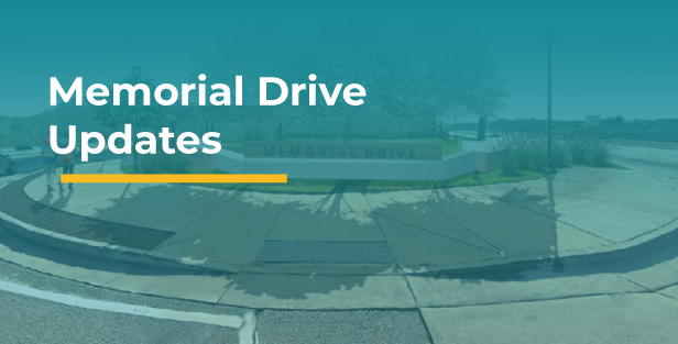 Section header for Memorial Drive Updates featuring the title over a teal-tinted photograph of the Memorial Drive monument sign at a landscaped streetscape entrance.