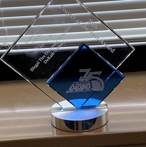 Close-up of the 2026 Project of the Year Award presented by the Georgia Chapter of the American Public Works Association (APWA) to the DeKalb County Department of Solid Waste Management for its Illegal Tire Dump Community Initiative.
