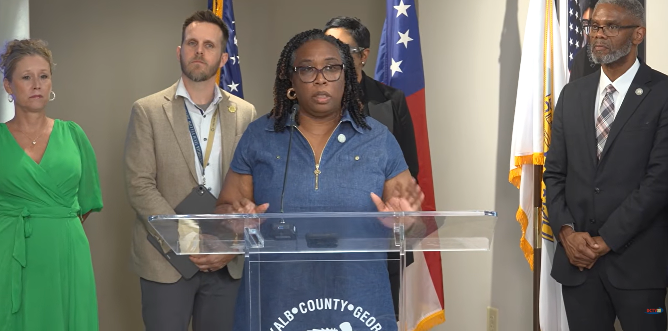 Commissioner Chakira Johnson speaks at a podium during the 