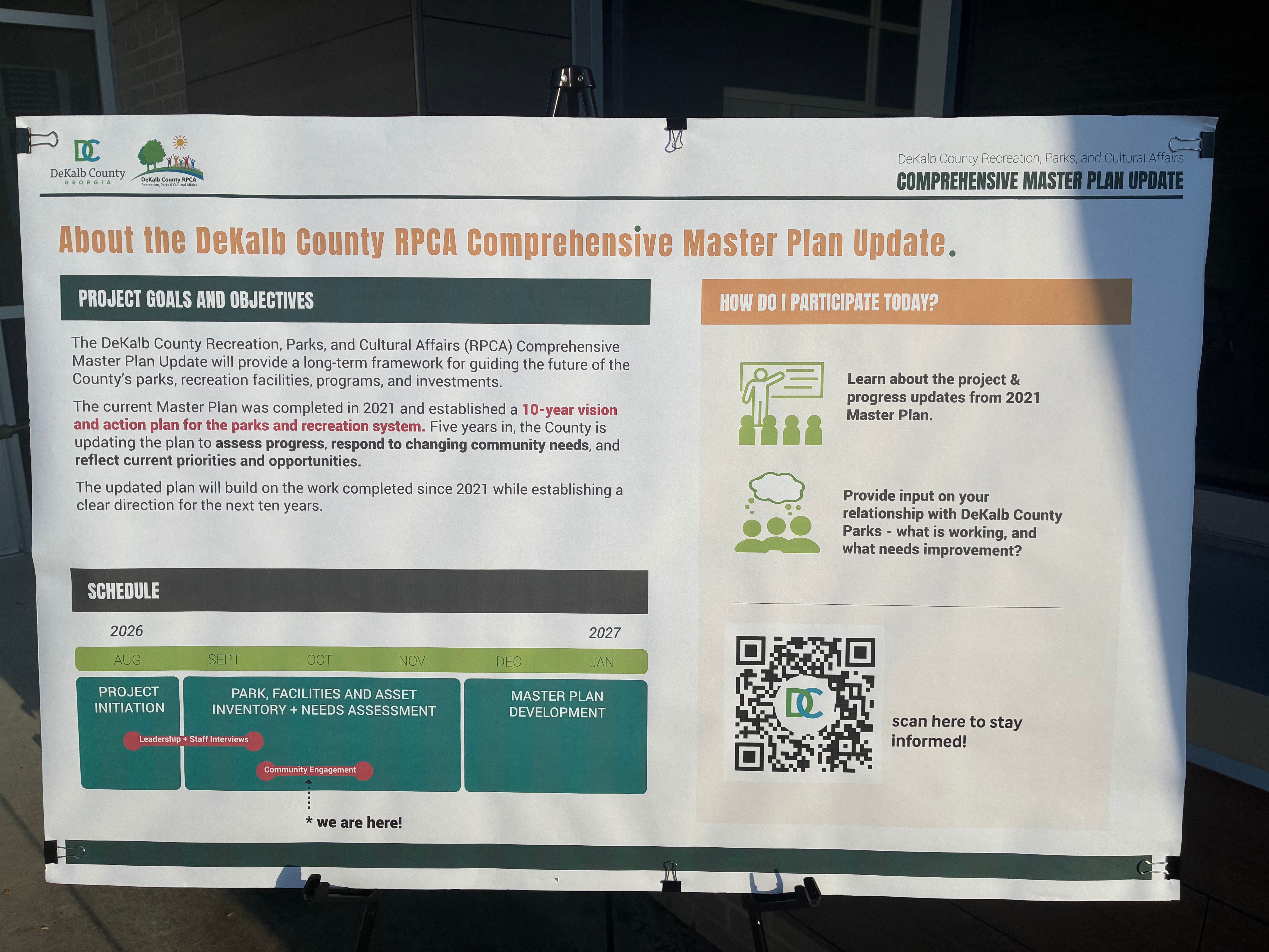 DeKalb County Recreation, Parks and Cultural Affairs Comprehensive Master Plan Update display explaining the five-year review of the County’s 2021 parks and recreation master plan. The update will assess progress, respond to changing community needs and guide future priorities for parks, recreation facilities, programs and investments. A timeline shows project initiation, park and facility inventory and needs assessment, community engagement, and master plan development from August 2026 through January 2027. Residents are invited to learn about progress since 2021 and provide input on what is working and what needs improvement in DeKalb County parks.
