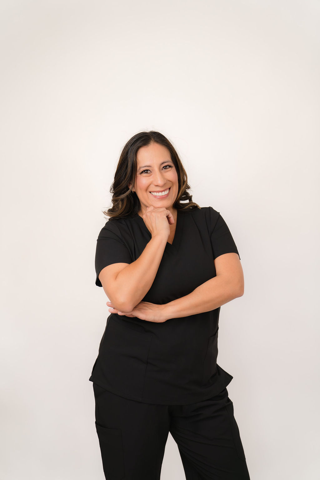 Stephanie Garcia, RDH, OMT, MS, smiling in black scrubs